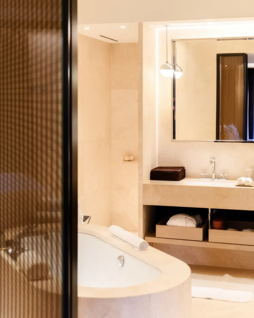 Elegant marble bathroom with a freestanding bathtub, glass shower and refined finishes at Bulgari Hotel Milano