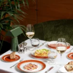 Fine dining spread featuring plated dishes, fresh ingredients and elegant tableware at a Bulgari hotel