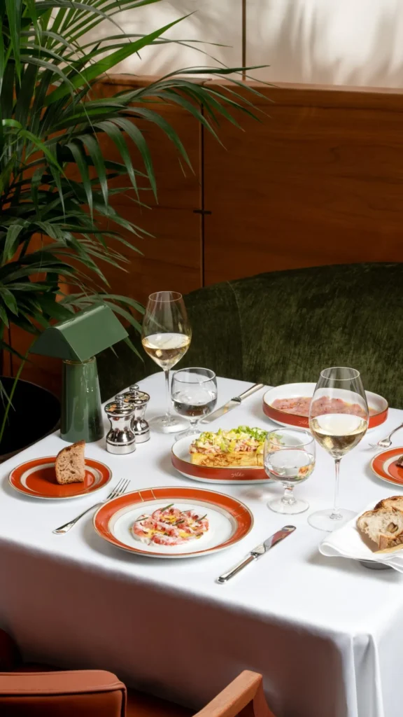 Fine dining spread featuring plated dishes, fresh ingredients and elegant tableware at a Bulgari hotel