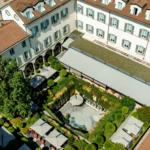 Aerial view of the historic hotel buildings surrounding the landscaped inner courtyard at Four Seasons Hotel Milano