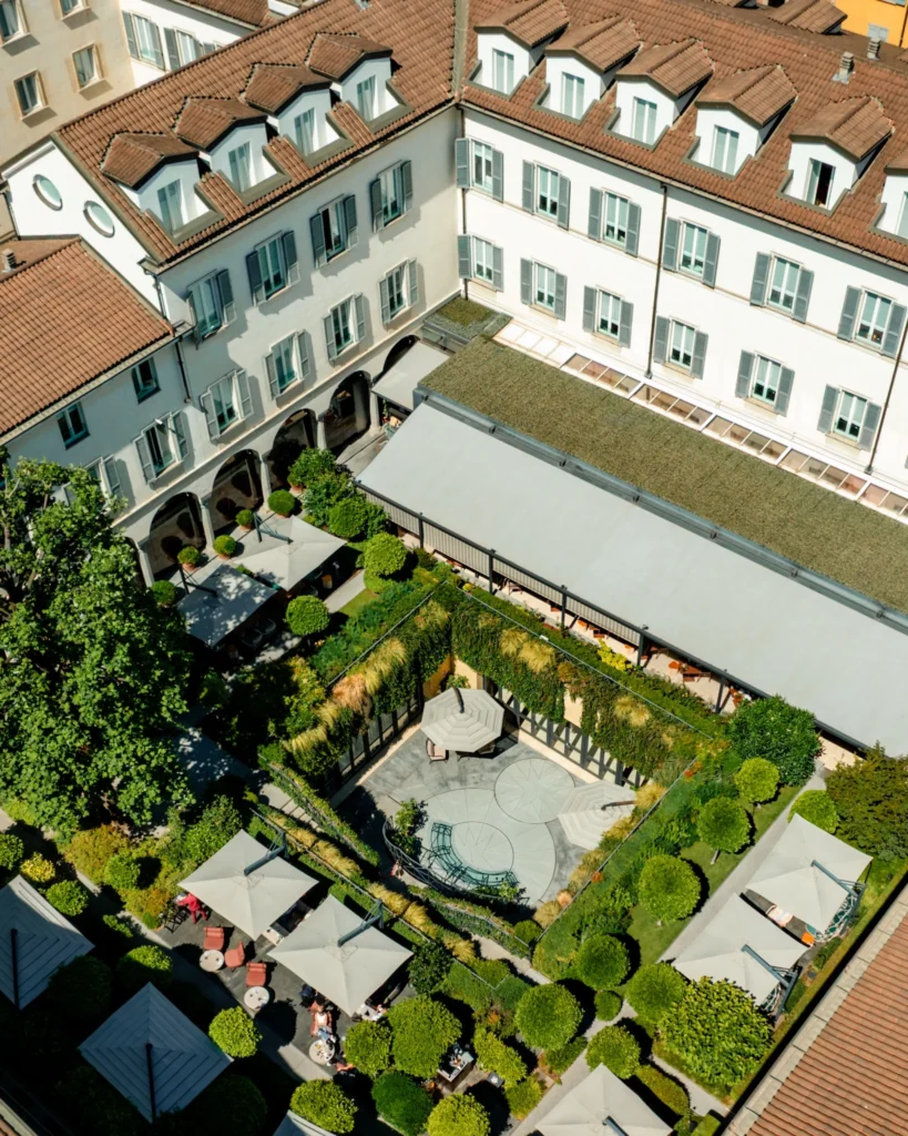 Aerial view of the historic hotel buildings surrounding the landscaped inner courtyard at Four Seasons Hotel Milano