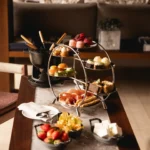Afternoon tea service with pastries, fresh fruit and elegant tableware at Four Seasons Hotel Milano