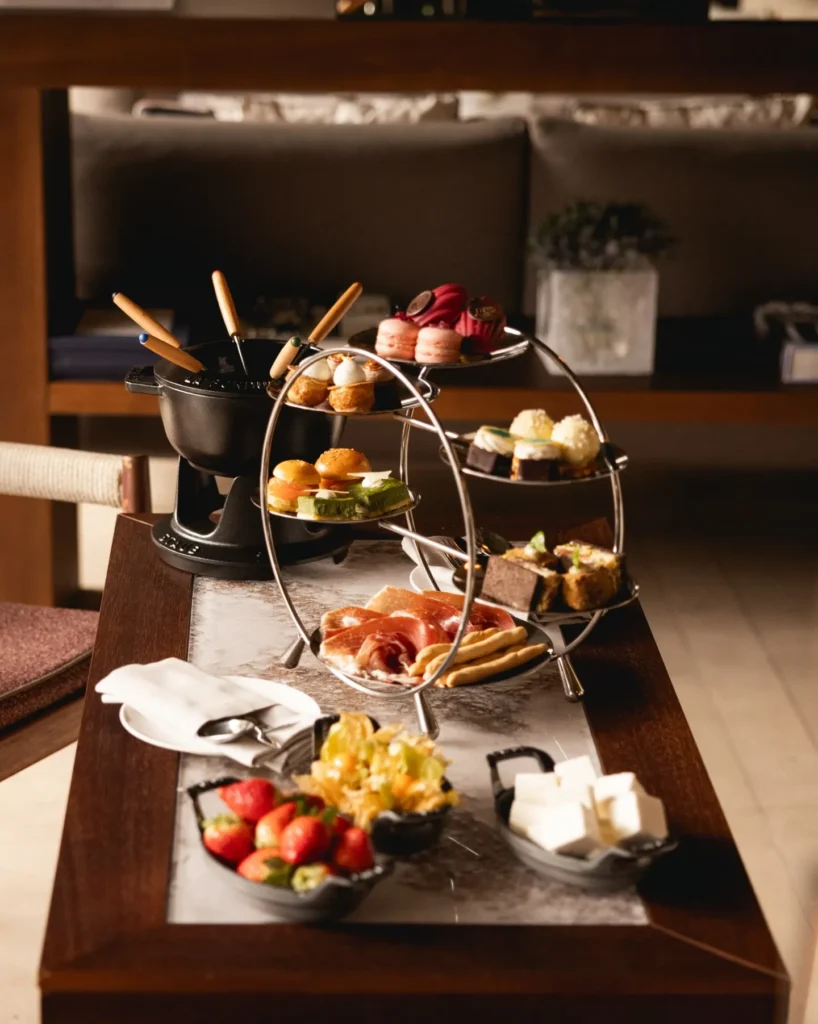 Afternoon tea service with pastries, fresh fruit and elegant tableware at Four Seasons Hotel Milano