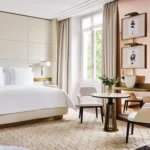Bright luxury hotel bedroom with a king-size bed, neutral furnishings and elegant decorative details at Four Seasons Hotel Milano