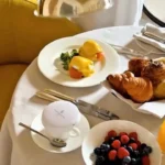 Breakfast spread featuring pastries, fresh fruit and prepared dishes served in a bright hotel dining setting at Four Seasons Hotel Milano