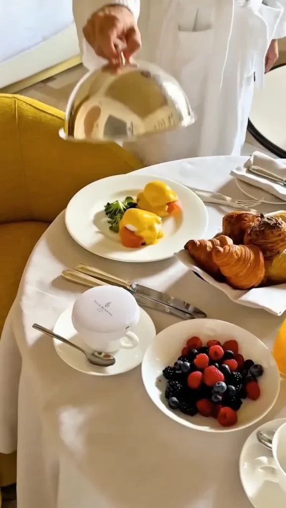 Breakfast spread featuring pastries, fresh fruit and prepared dishes served in a bright hotel dining setting at Four Seasons Hotel Milano