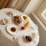 Elegant breakfast table with pastries, fruit, coffee and plated dishes at Four Seasons Hotel Milano
