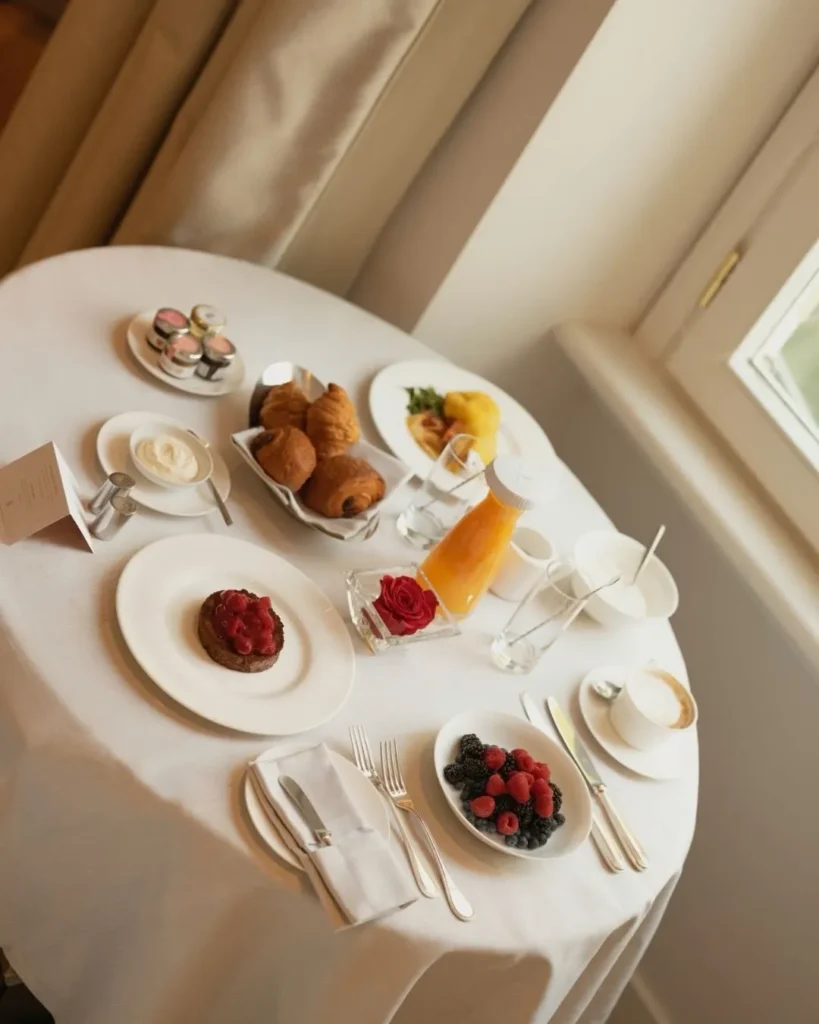 Elegant breakfast table with pastries, fruit, coffee and plated dishes at Four Seasons Hotel Milano