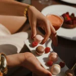 A server carefully placing a dessert on a plate during a refined dining experience at Four Seasons Hotel Milano
