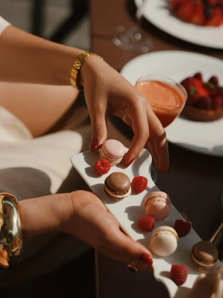 A server carefully placing a dessert on a plate during a refined dining experience at Four Seasons Hotel Milano