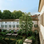 Beautiful landscaped garden courtyard with manicured hedges and outdoor seating at Four Seasons Hotel Milano