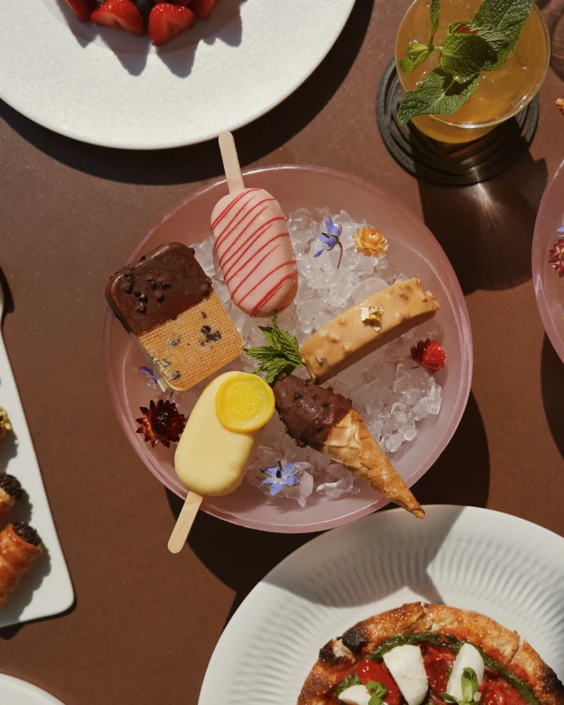 Overhead view of gourmet dishes and elegant table settings during a dining experience at Four Seasons Hotel Milano
