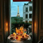 Romantic evening dining setup beside a window with Paris views at Hôtel Plaza Athénée