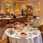 Elegant breakfast spread served at a beautifully set table in a lavish Parisian hotel dining room