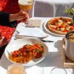 Beautifully presented gourmet dishes served with drinks at Hôtel Plaza Athénée Paris