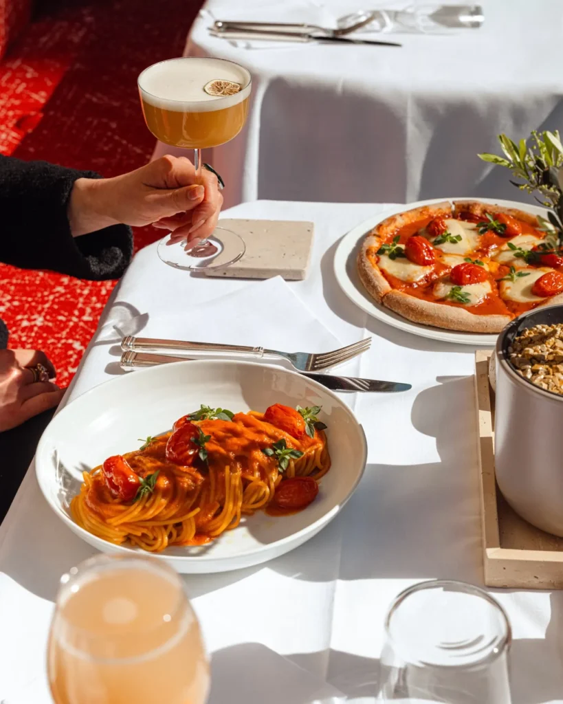 Beautifully presented gourmet dishes served with drinks at Hôtel Plaza Athénée Paris