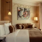 Refined bedroom with a comfortable bed and artwork at La Réserve Paris