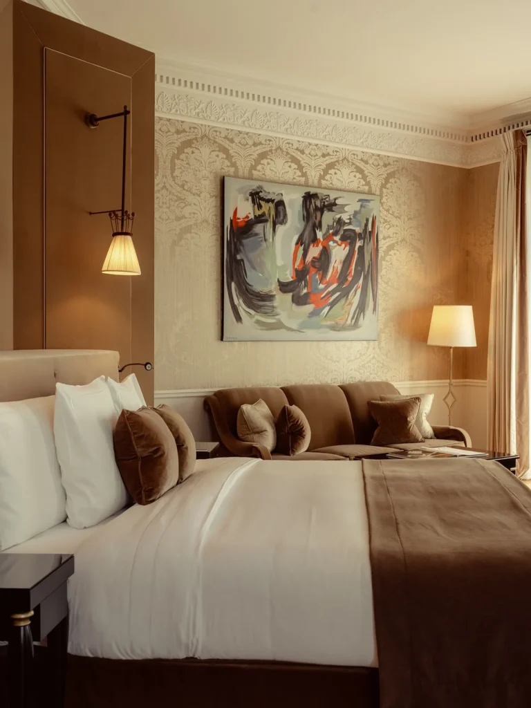 Refined bedroom with a comfortable bed and artwork at La Réserve Paris