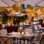 Elegant outdoor dining terrace illuminated by warm lights at La Réserve Paris