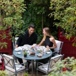Outdoor terrace table surrounded by lush greenery at La Réserve Paris