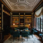 Elegant wood-panelled library lounge with bookshelves and refined seating at La Réserve Paris