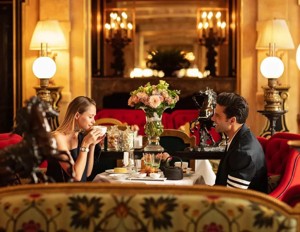 Guests enjoying an elegant meal in the red velvet dining room at La Réserve Paris