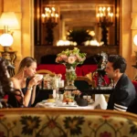 Guests enjoying an elegant meal in the red velvet dining room at La Réserve Paris