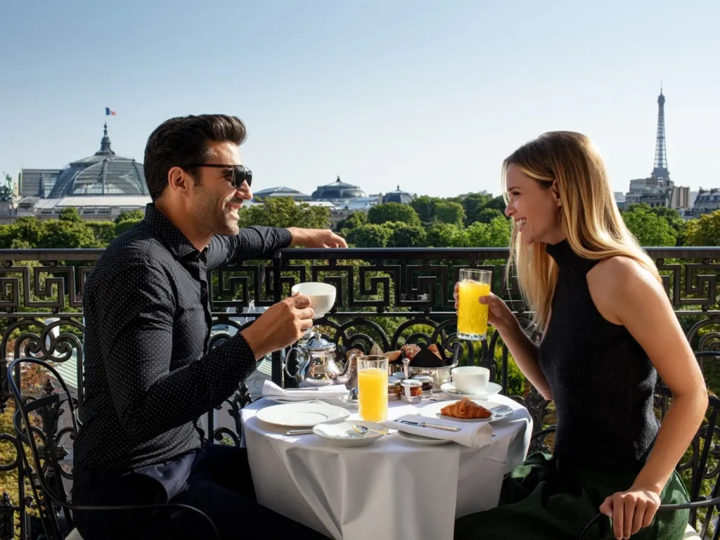 Guests dining on an outdoor terrace with panoramic Paris views at La Réserve Paris