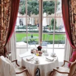 Elegant dining room with a table set for guests at Le Bristol Paris
