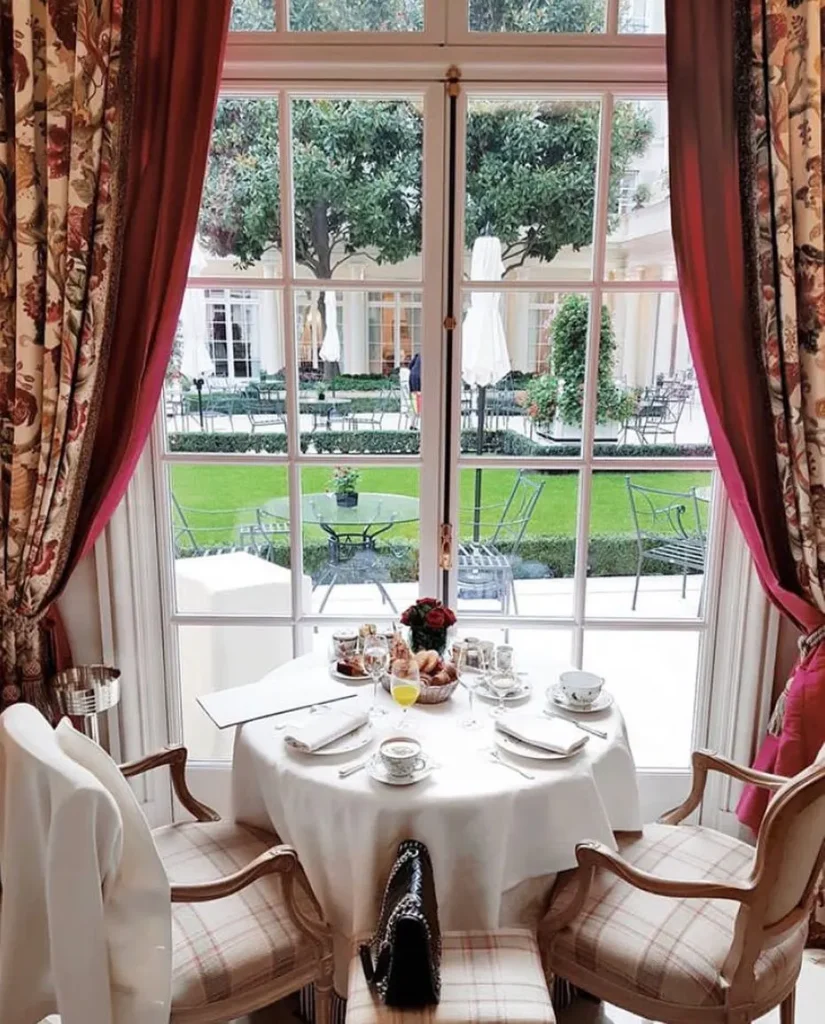 Elegant dining room with a table set for guests at Le Bristol Paris