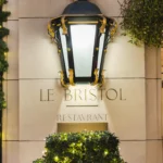 Le Bristol Paris entrance with its iconic lantern and floral display