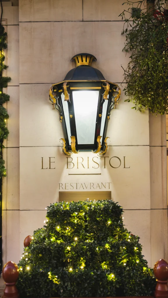 Le Bristol Paris entrance with its iconic lantern and floral display
