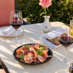 Charcuterie platter and wine served in the garden at Le Bristol Paris