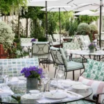 Outdoor restaurant tables surrounded by greenery at Le Bristol Paris