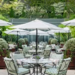 Outdoor garden seating surrounded by greenery at Le Bristol Paris
