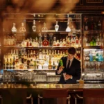 Elegant bar area with illuminated shelves at Le Meurice Paris