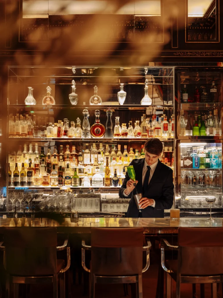 Elegant bar area with illuminated shelves at Le Meurice Paris