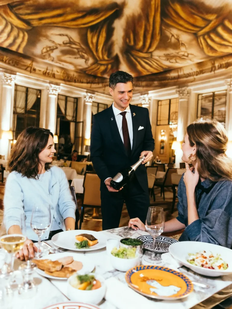 Guests enjoying a refined dining experience at Le Meurice Paris