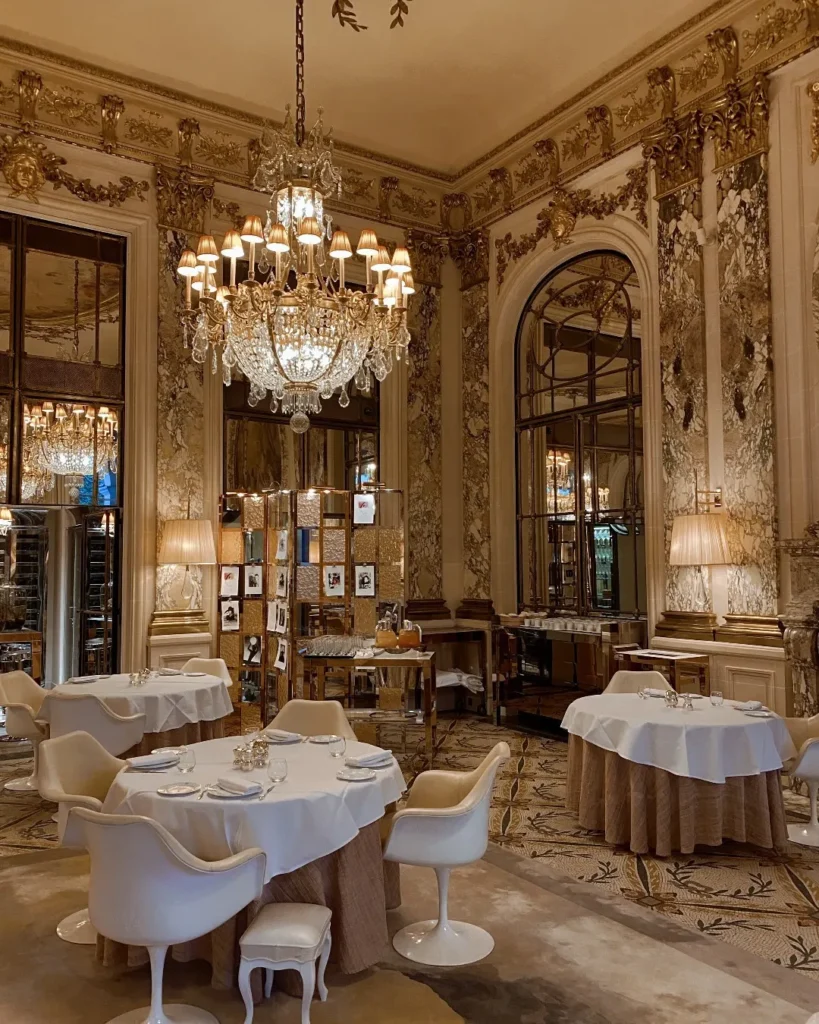 Luxurious dining interior at Le Meurice Paris with crystal chandeliers