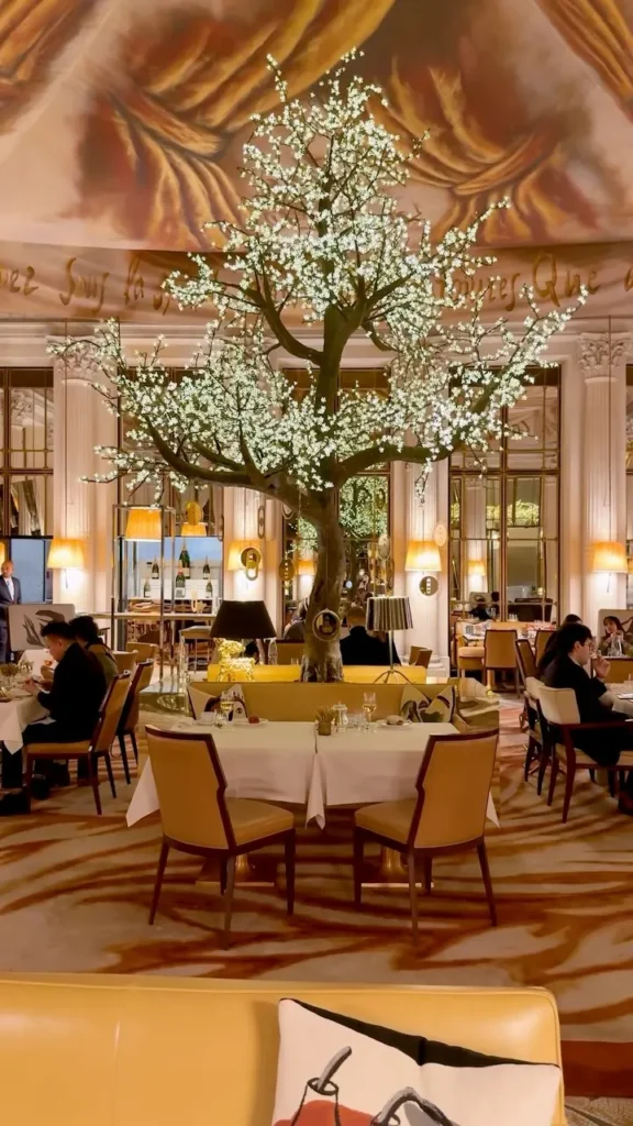 Elegant Le Meurice Paris dining room beneath an ornate chandelier