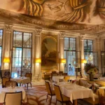 Gilded dining room with chandeliers and refined table settings at Le Meurice Paris