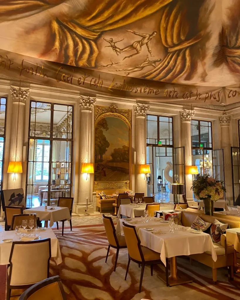 Gilded dining room with chandeliers and refined table settings at Le Meurice Paris