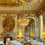 Gilded dining room with crystal chandeliers at Le Meurice Paris