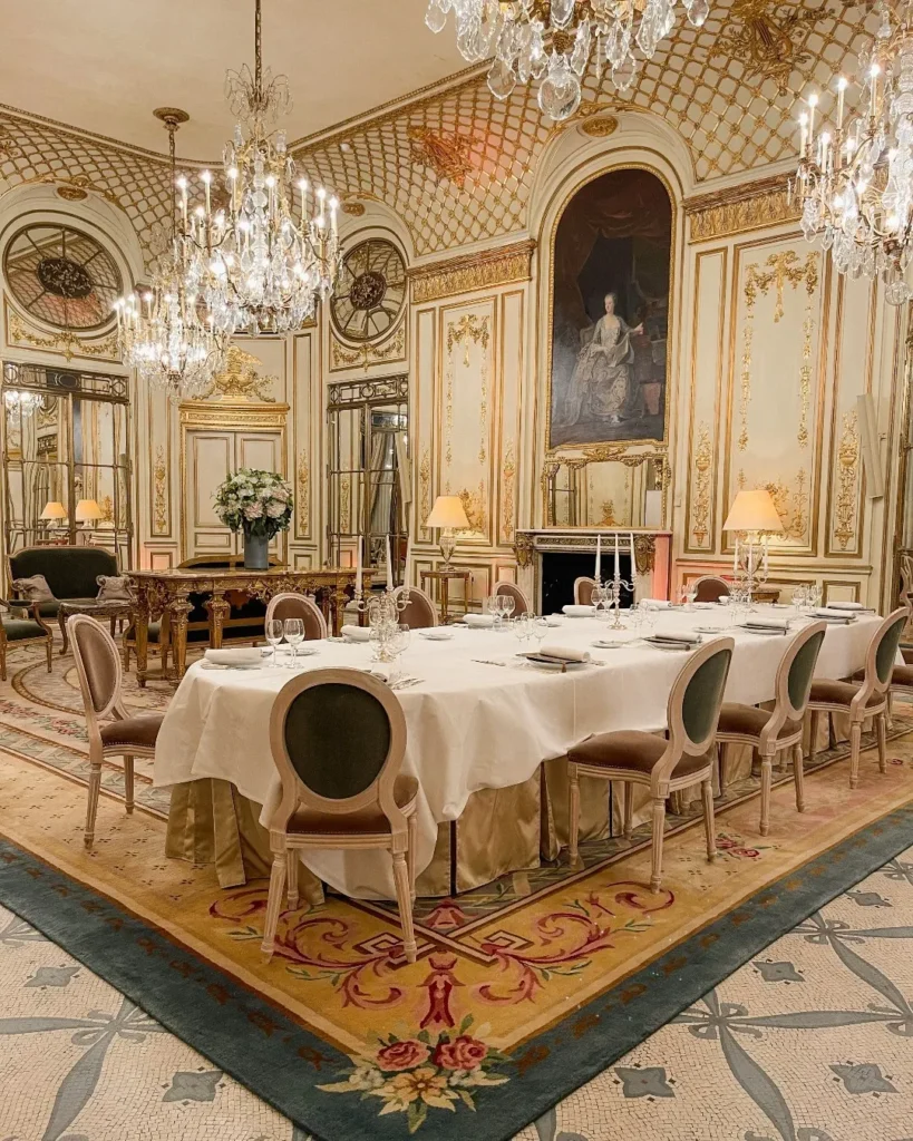Elegant dining room at Le Meurice Paris with ornate interiors and chandeliers