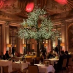 Atmospheric evening dining room at Le Meurice Paris with warm lighting