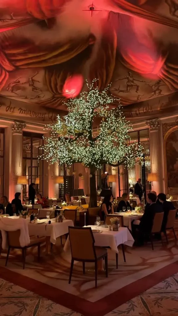 Atmospheric evening dining room at Le Meurice Paris with warm lighting