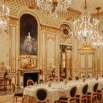 Opulent restaurant dining room at Le Meurice Paris with ornate gold details