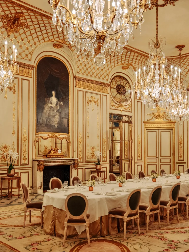 Opulent restaurant dining room at Le Meurice Paris with ornate gold details