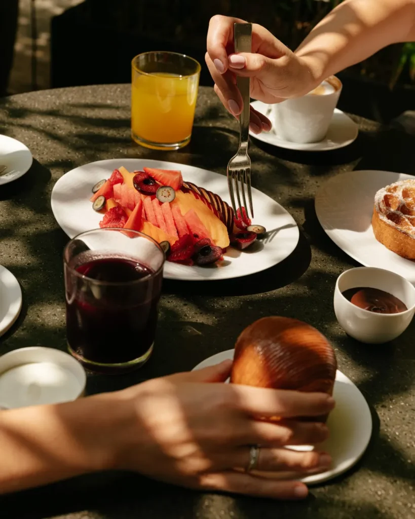 Colorfully plated gourmet dessert served alongside drinks and small dishes at Mandarin Oriental Milan