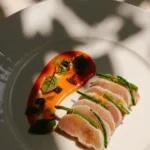 Artfully plated sushi with colorful garnishes served at a fine dining restaurant at Mandarin Oriental Milan
